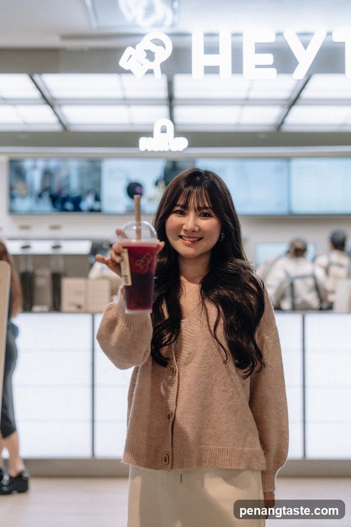 Woman holding a drink in a cafe interior