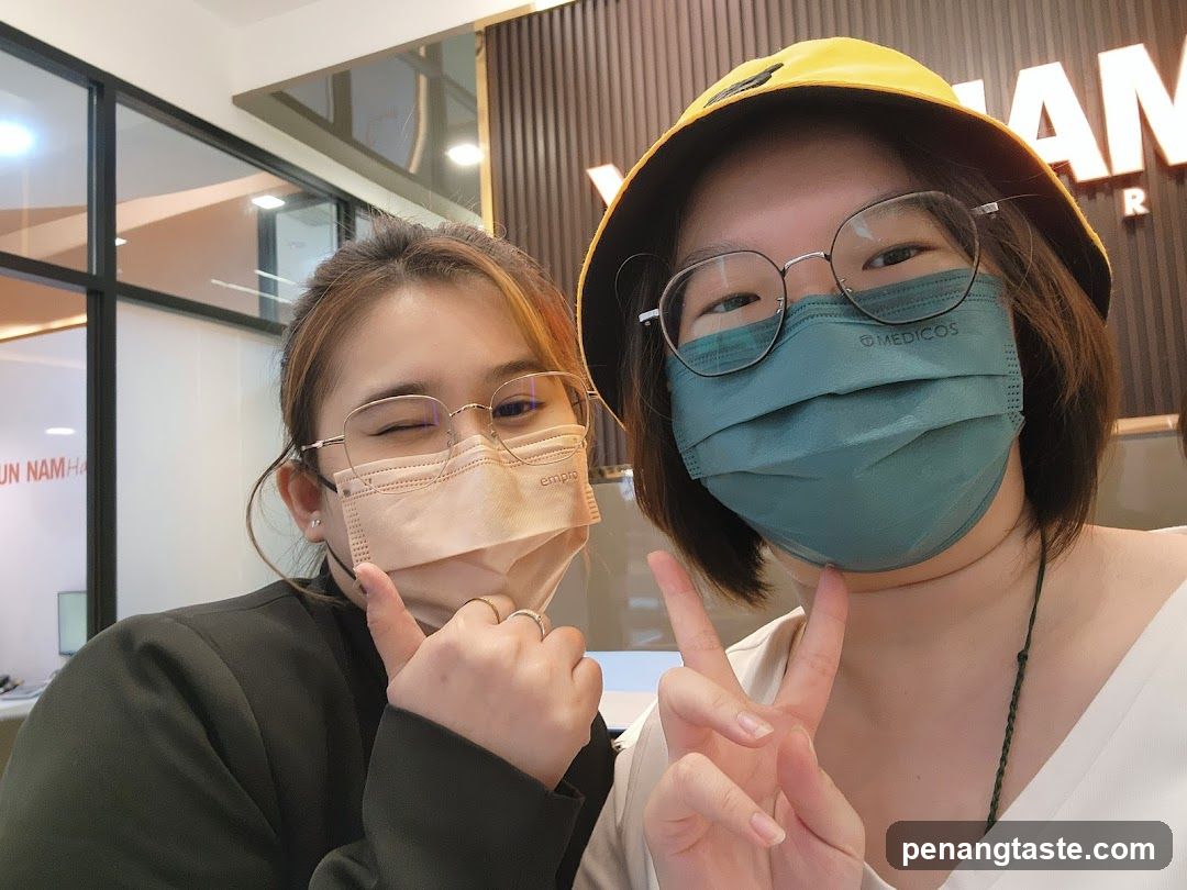 Two people wearing masks indoors