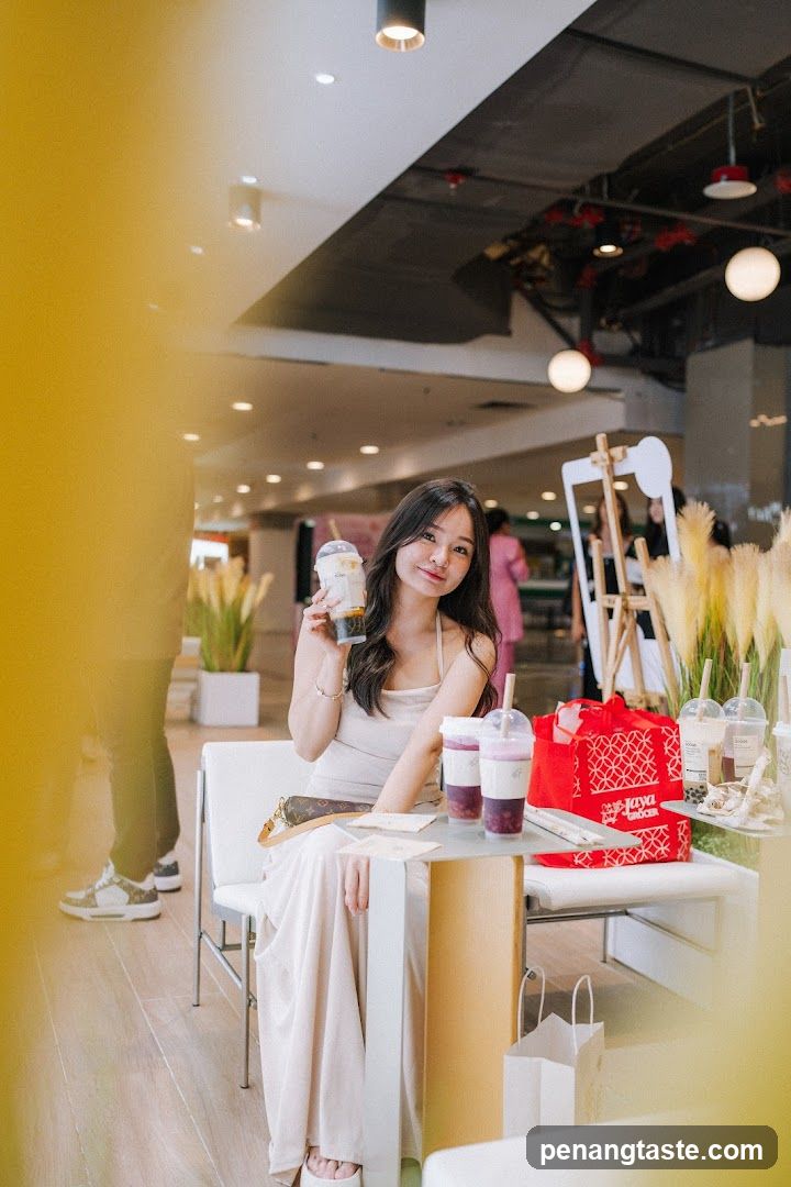 Woman holding drink in cafe interior