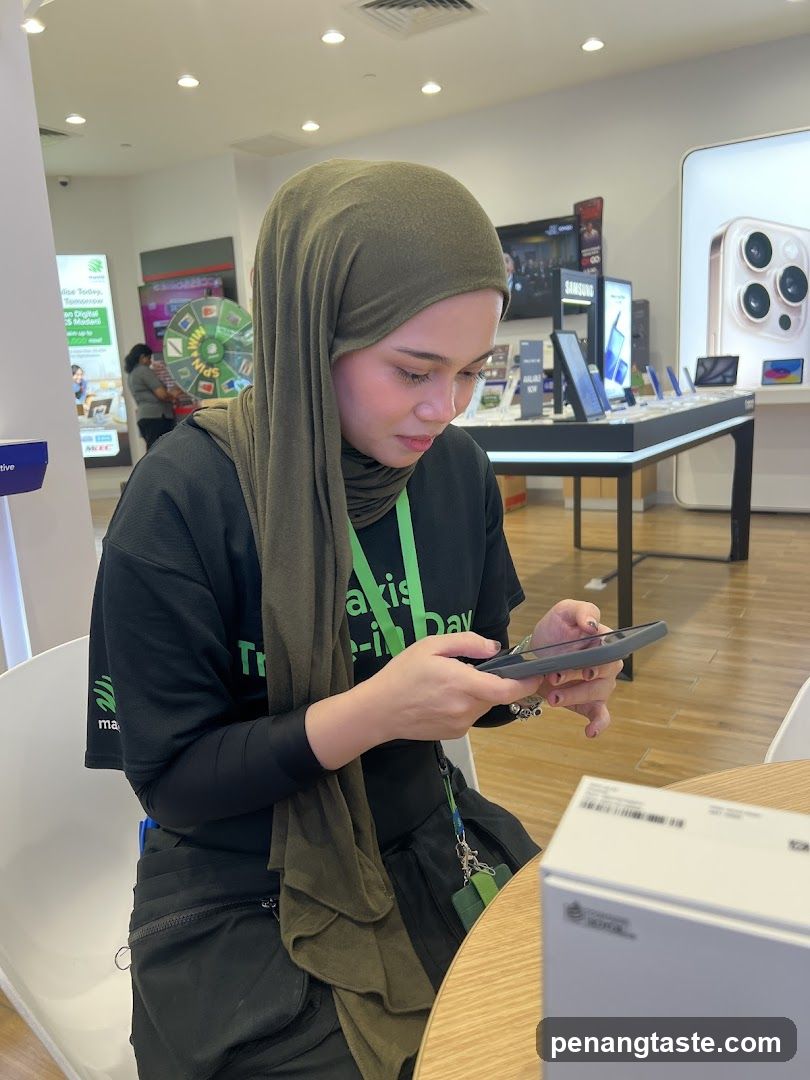 Staff using phone in electronics store