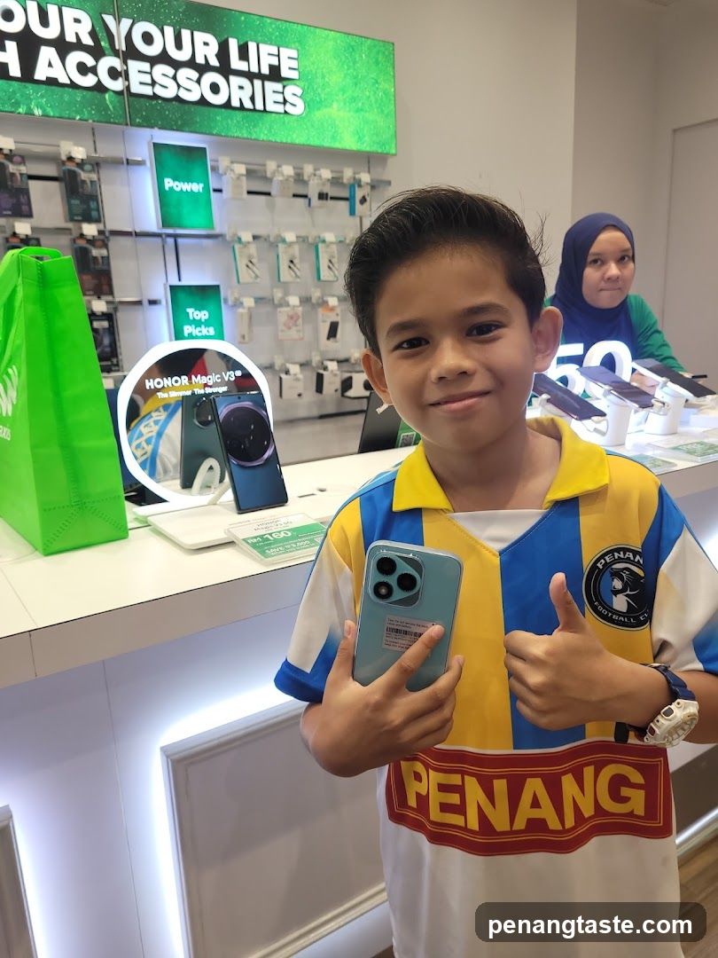 Boy holding phone in electronics store