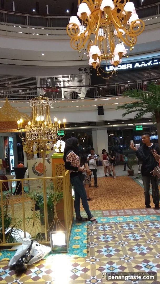 Shopping Mall Interior with Chandeliers and Shoppers