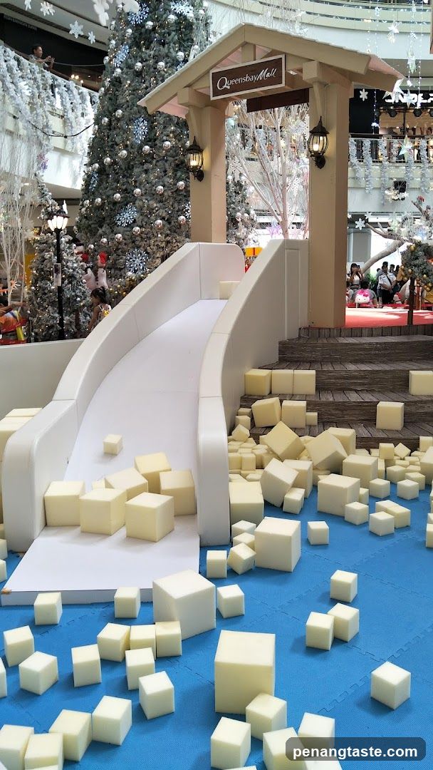 Christmas-themed indoor display with white cubes and slide