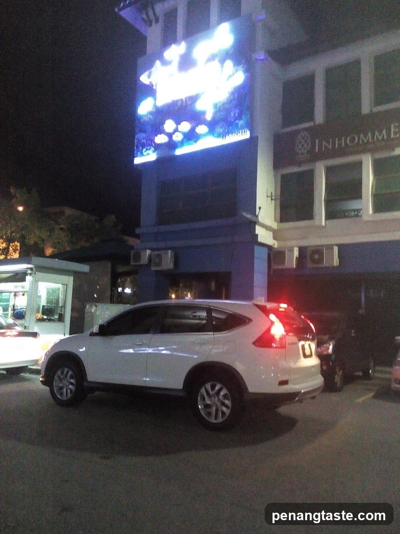 Night scene with parked cars and building facade