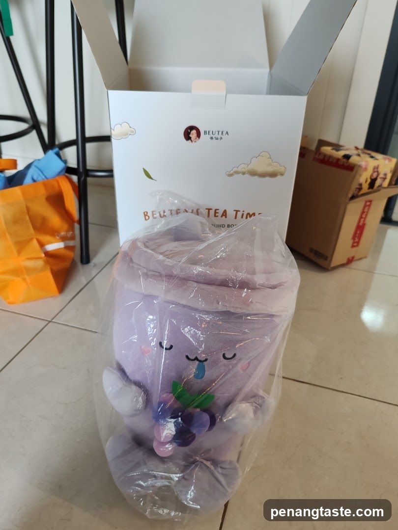 Purple plush tea cup in packaging