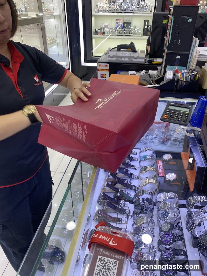 Watch Store Interior with Staff Handing Bag