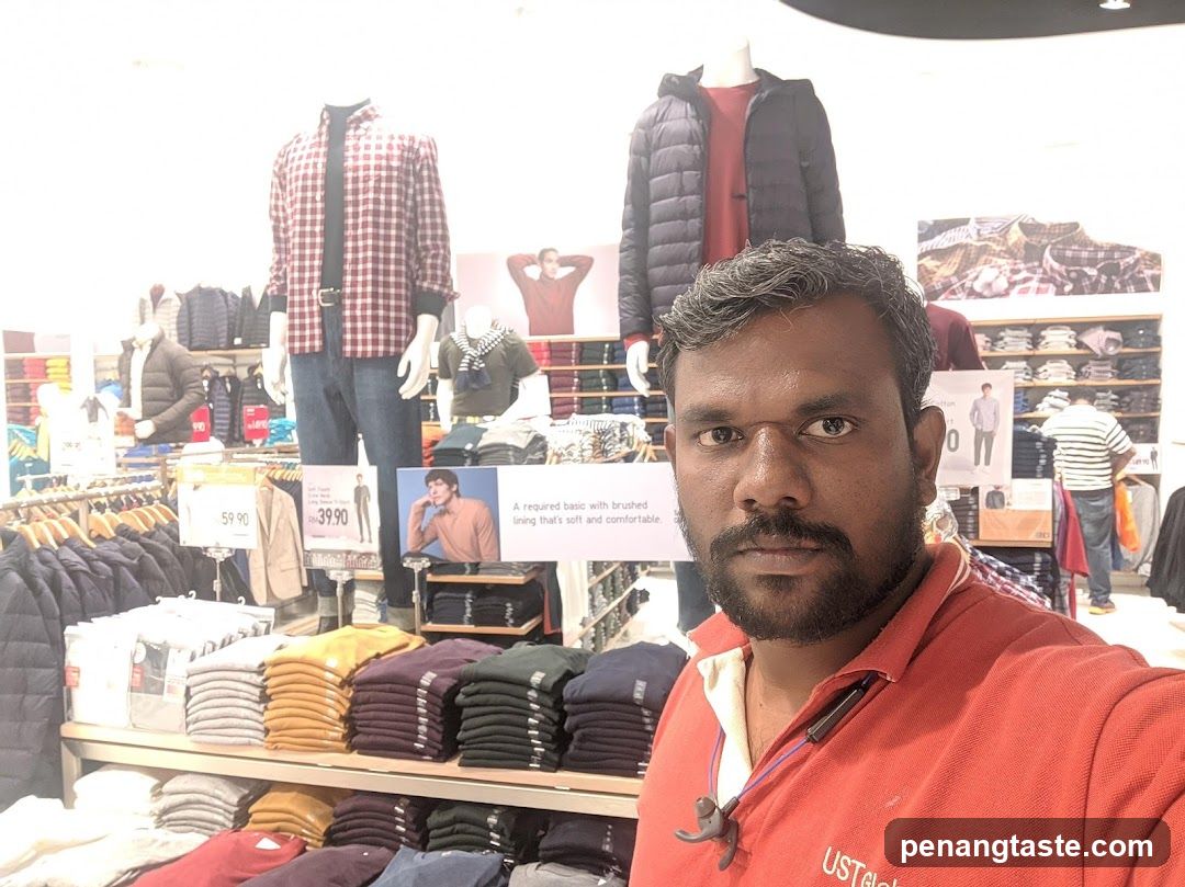 Man in clothing store aisle