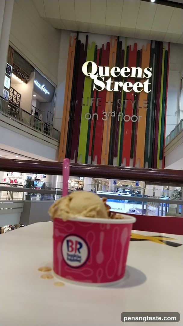 Ice cream in mall with Queens Street sign