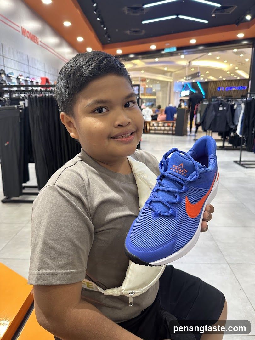 Boy Holding Blue Nike Shoe in Store