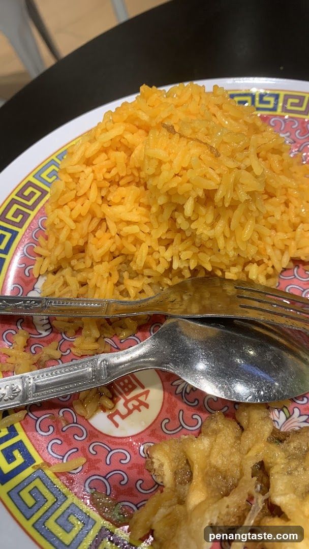 Plate of Yellow Rice and Fried Food