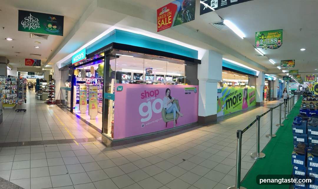 Shopping Mall Interior with Storefronts and Advertisements