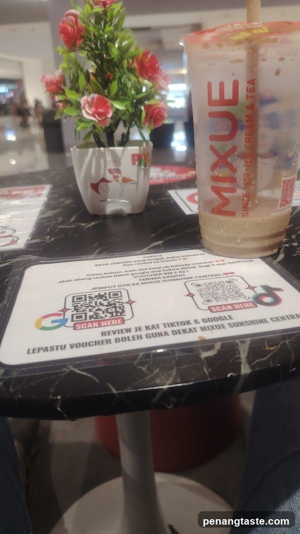 Mixue Drink and Voucher Card on Table