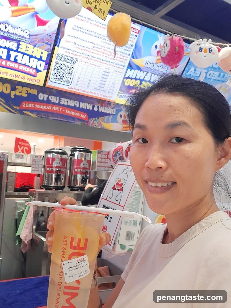 Person holding a drink at a food stall