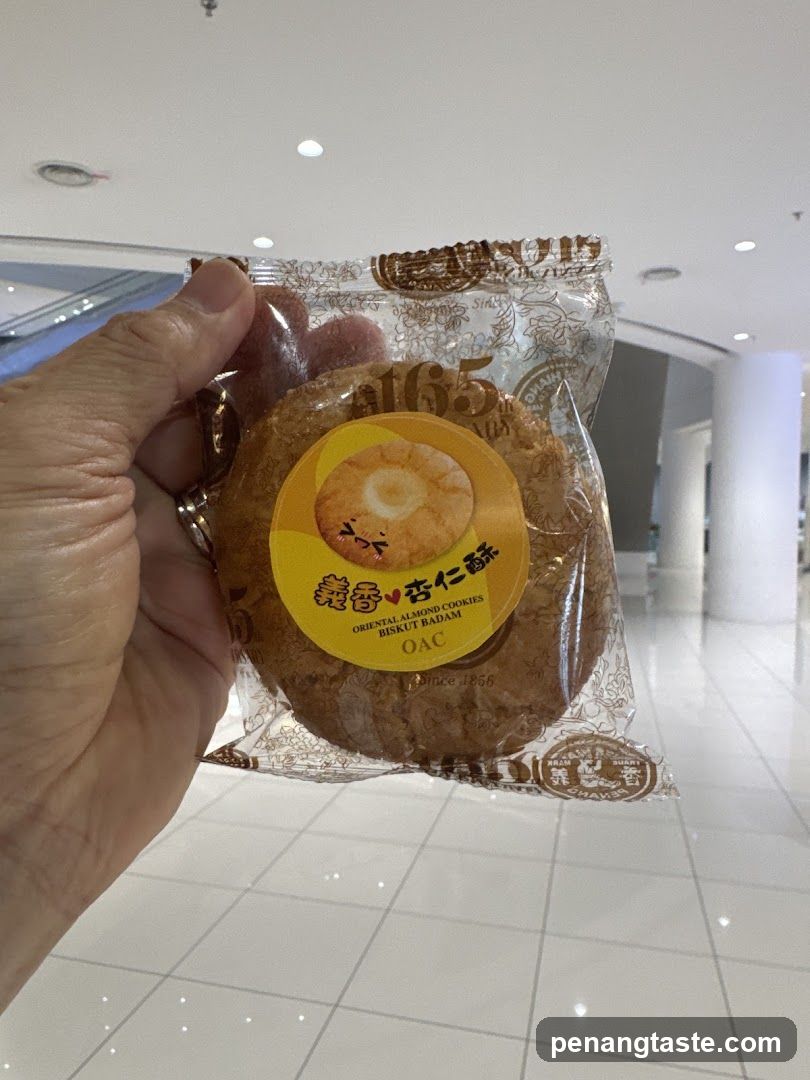 Hand holding packaged almond cookies