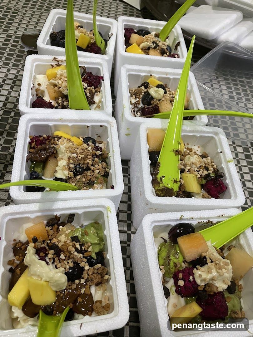 Fruit Yogurt Bowls with Granola and Green Spoons