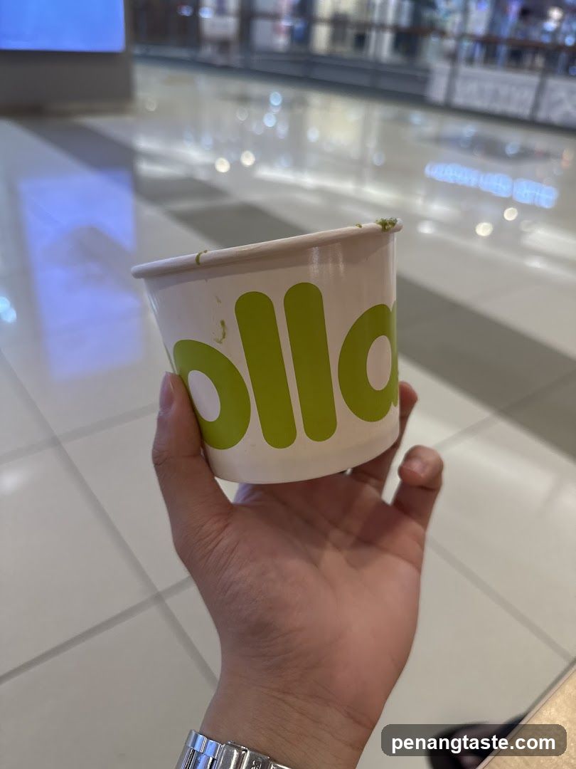 Hand holding a cup with 'ollo' visible