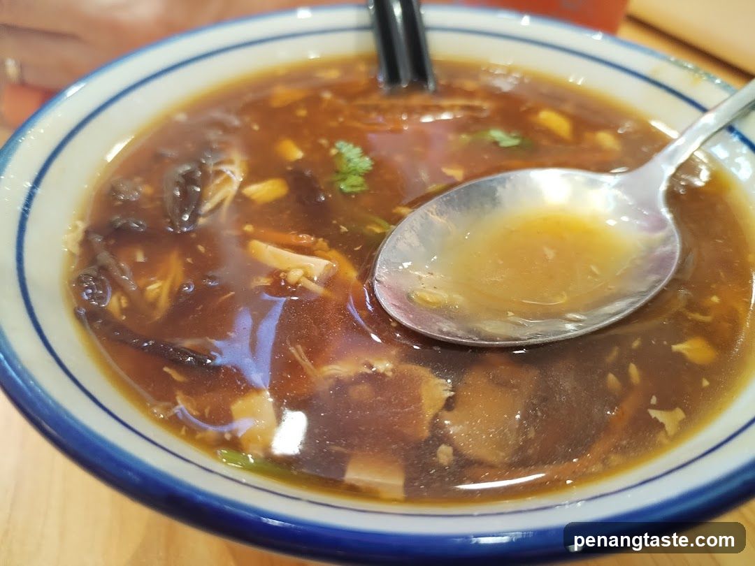 Bowl of Soup with Chopsticks and Spoon