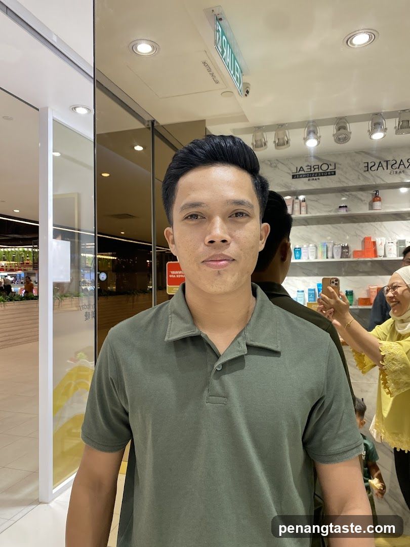 Man in Green Polo Shirt at Store Entrance