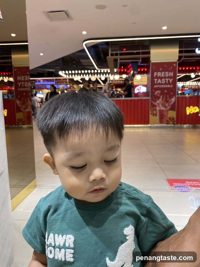 Child in Green Shirt at Food Court