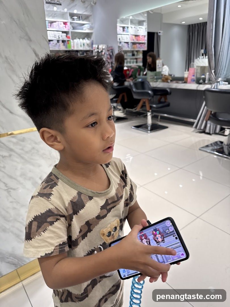 Child in Hair Salon Holding Phone