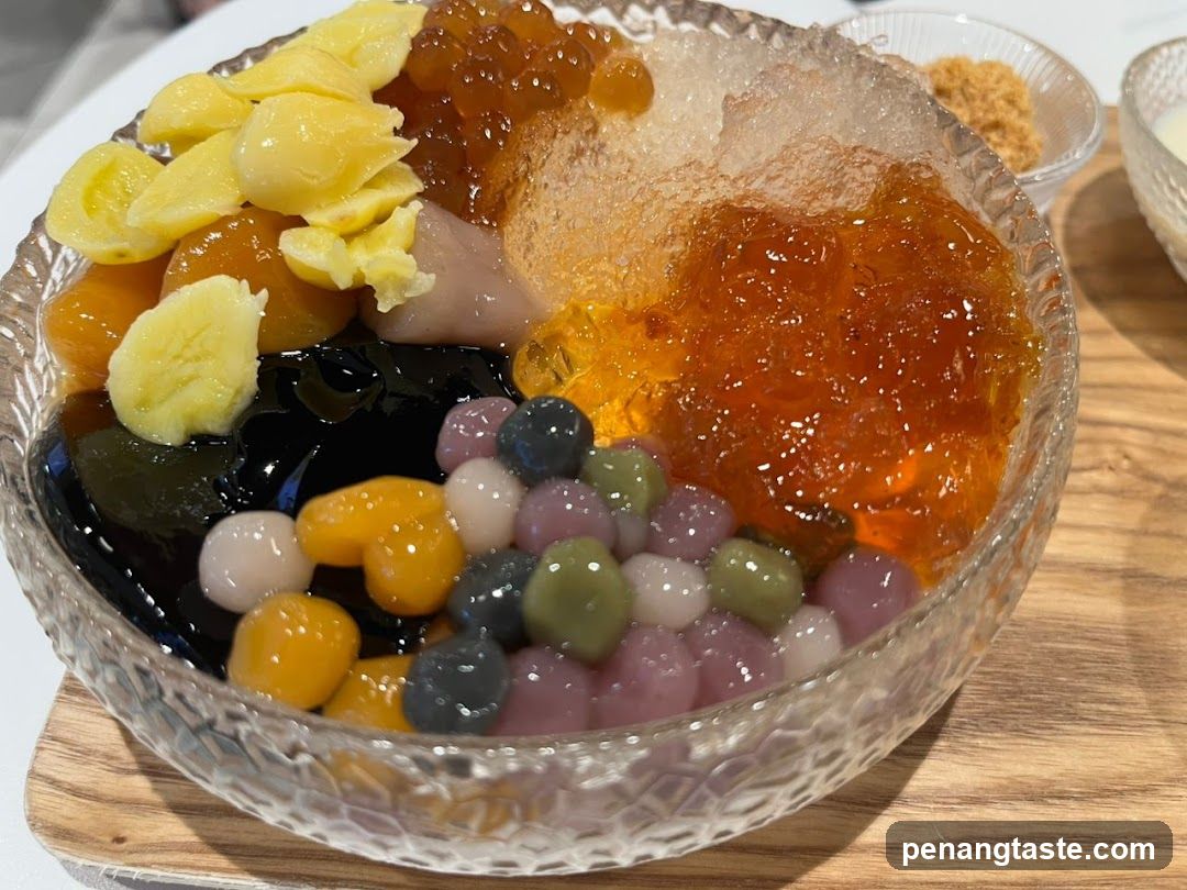 Bowl of colorful dessert with tapioca pearls, jelly cubes, and fruit pieces