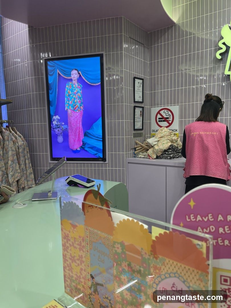 Interior of a clothing store with digital display and staff
