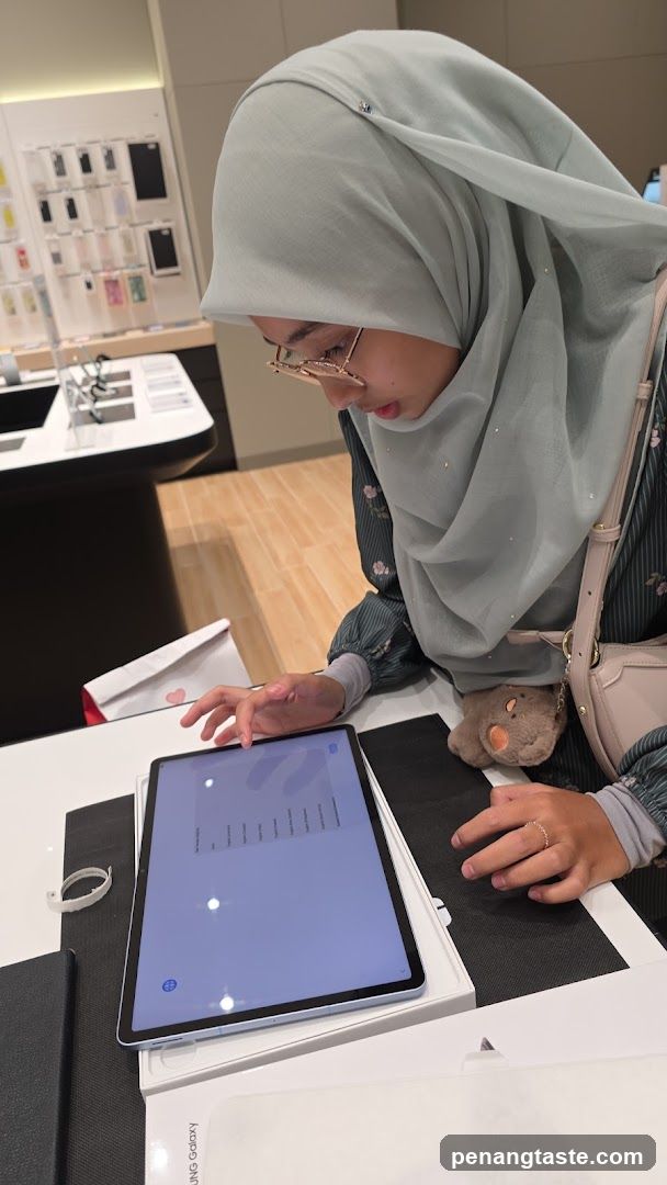 Woman examining tablet in store
