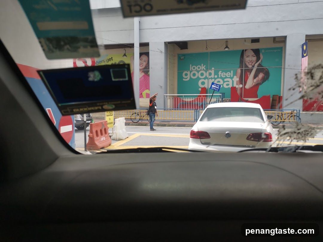 Car Interior View with Storefront and Advertisement