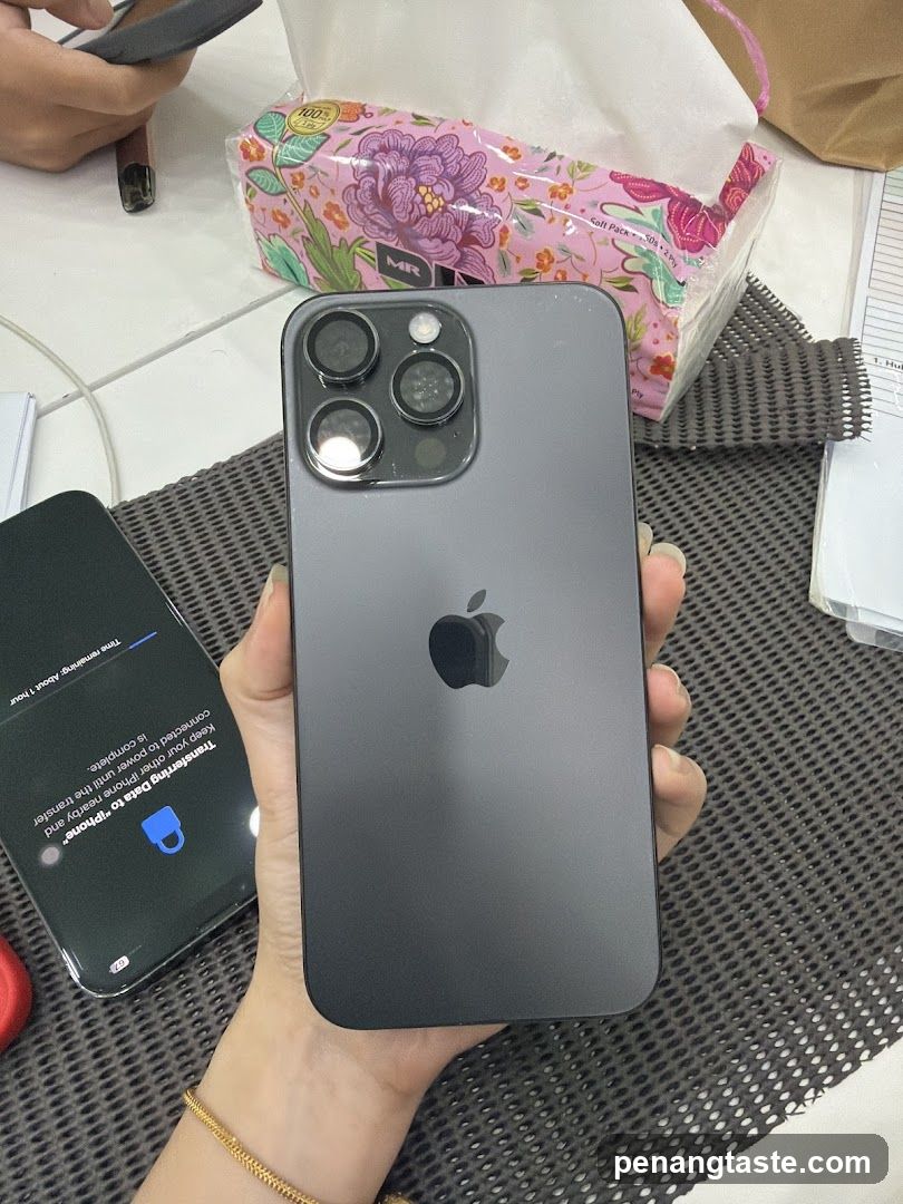 iPhone in hand with tissue box nearby