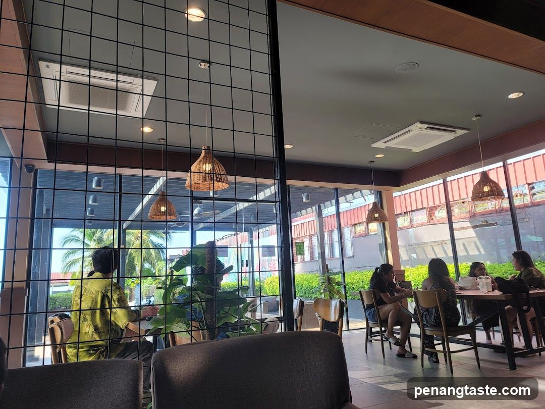 Interior View of a Modern Cafe with Large Windows and Hanging Lights