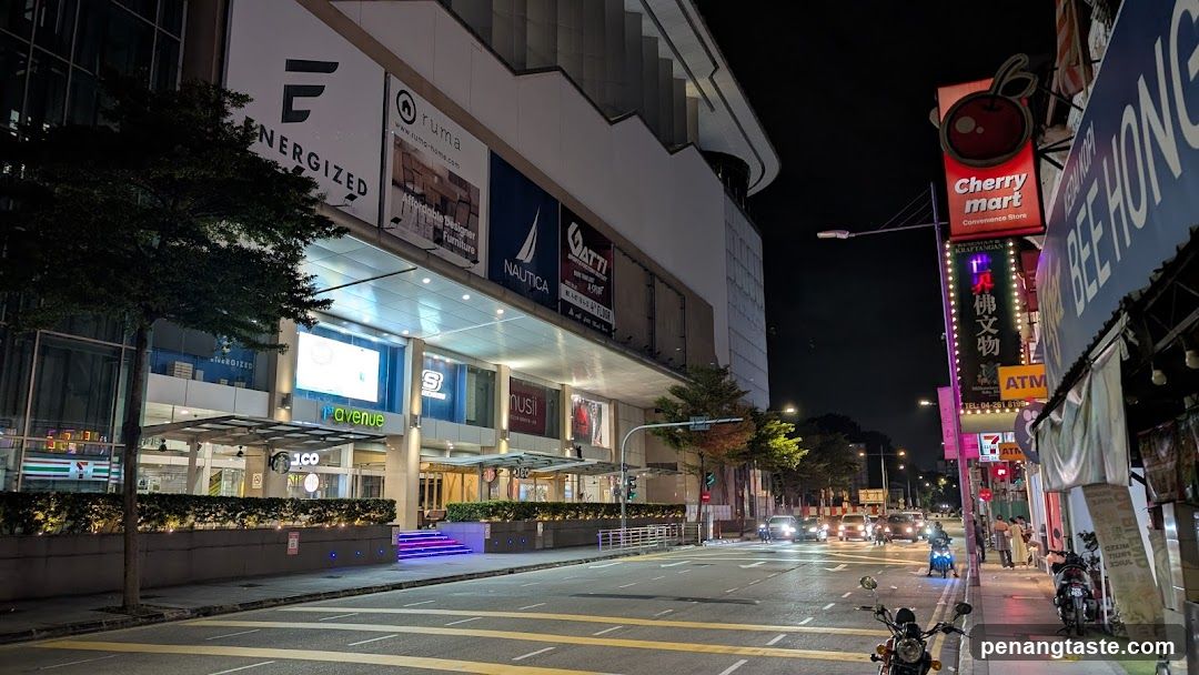 Night Street Scene with Storefronts and Traffic