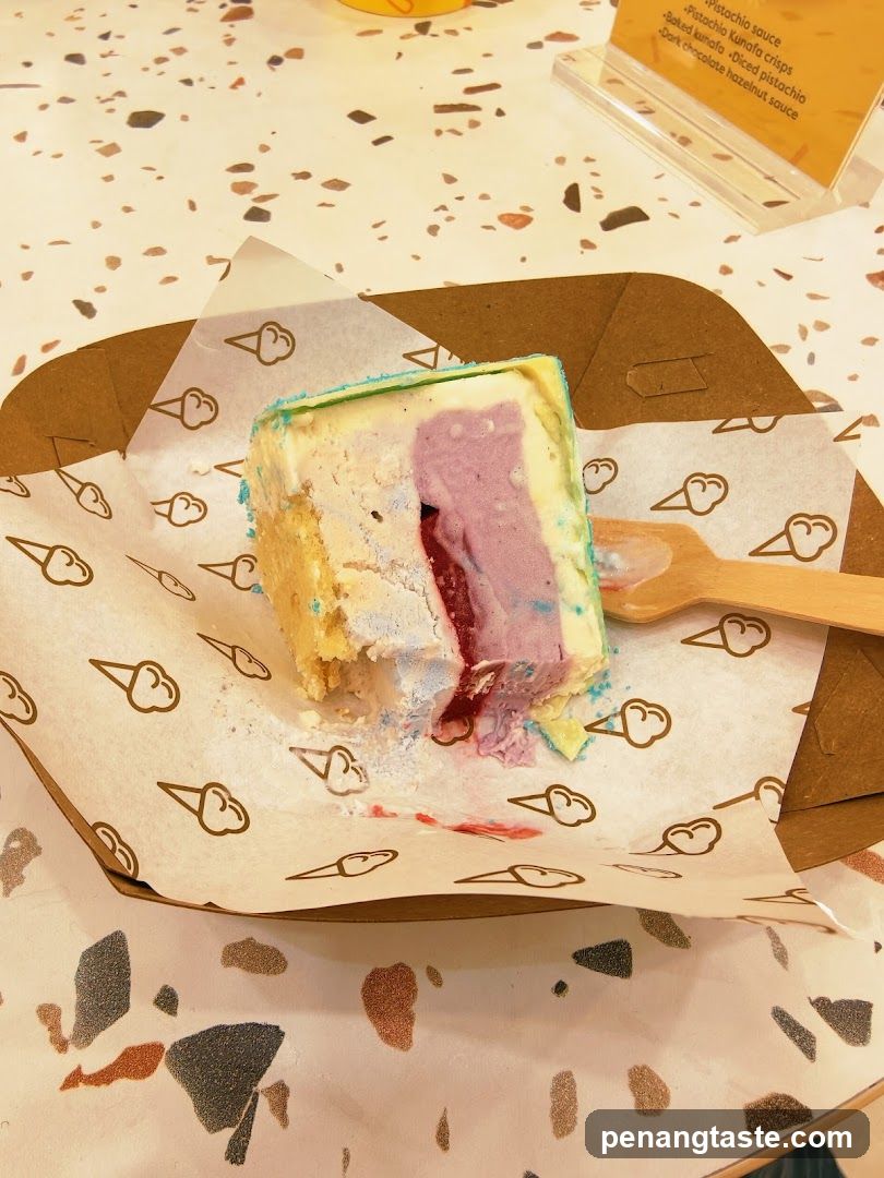 Slice of colorful cake in a paper-lined tray