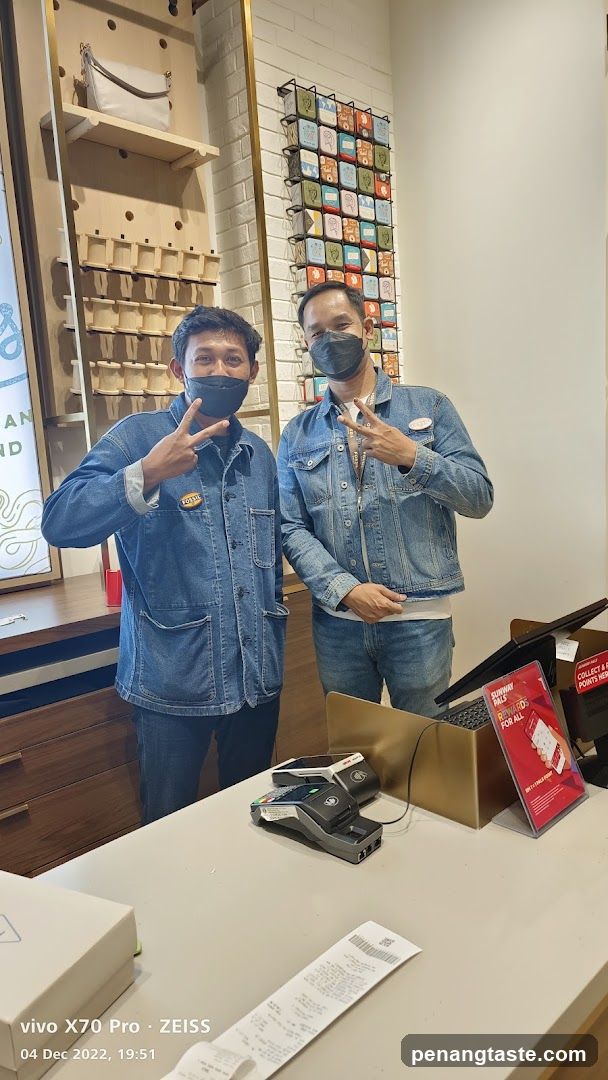 Two men in denim jackets posing indoors