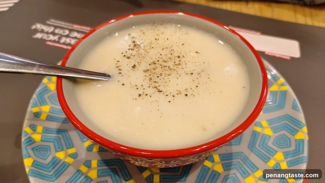 Bowl of creamy soup with pepper