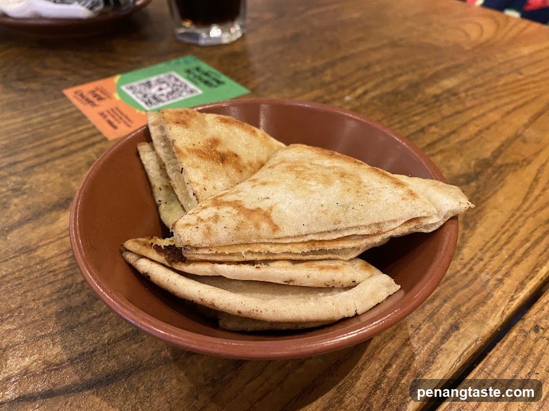 Bowl of Pita Bread on Wooden Table