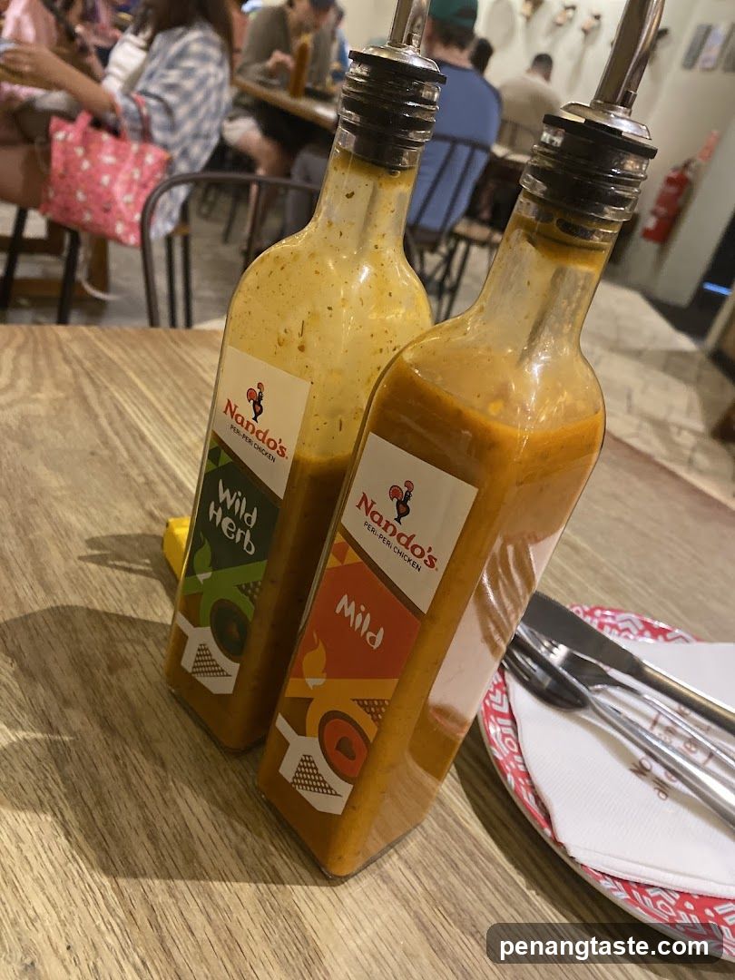 Nando's Sauce Bottles on Table