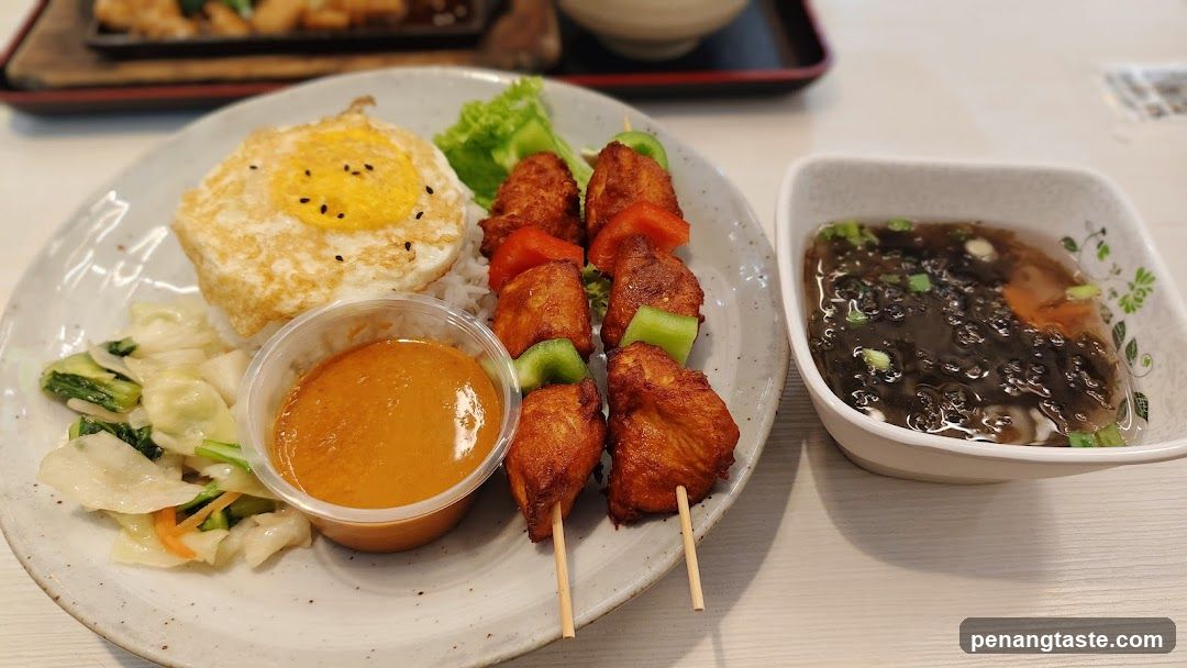 Asian-style meal with skewers and sauce