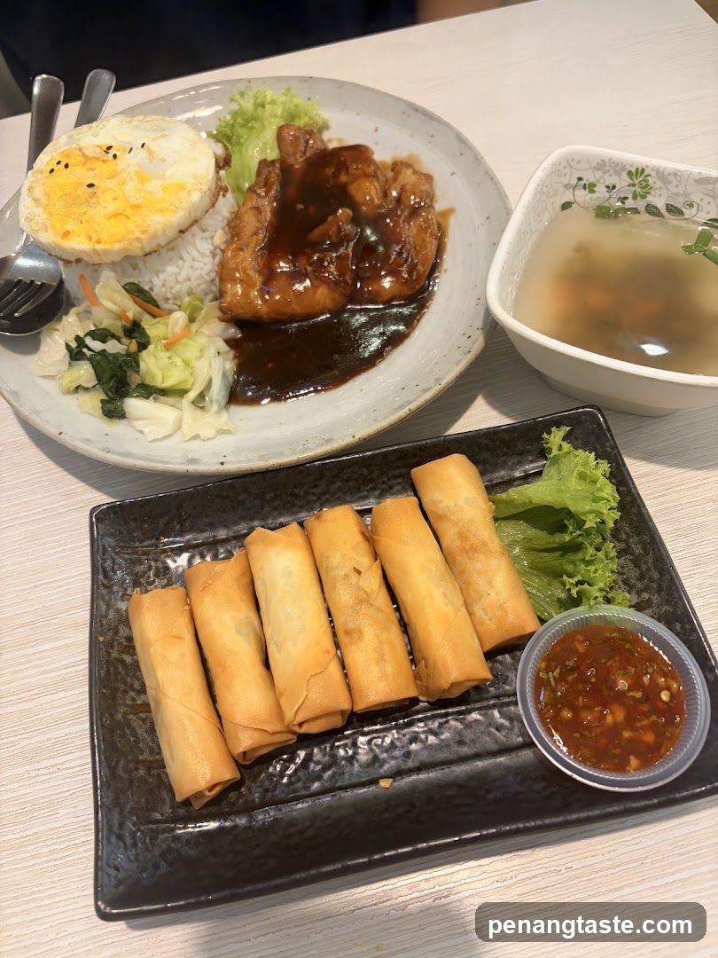 Food Spread with Spring Rolls and Rice Dish