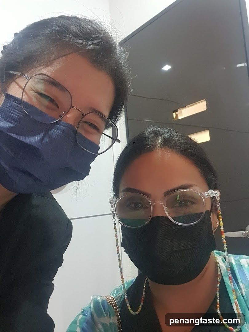 Two people wearing masks indoors