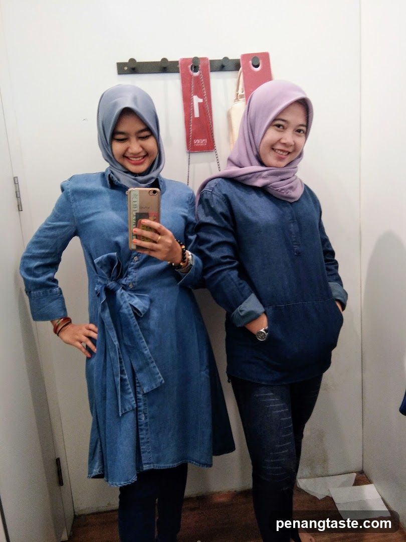 Two women in denim outfits taking a selfie