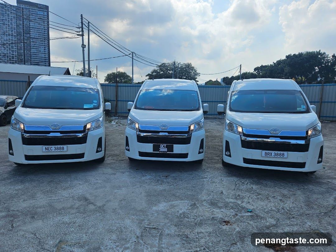 Three white Toyota vans parked outdoors