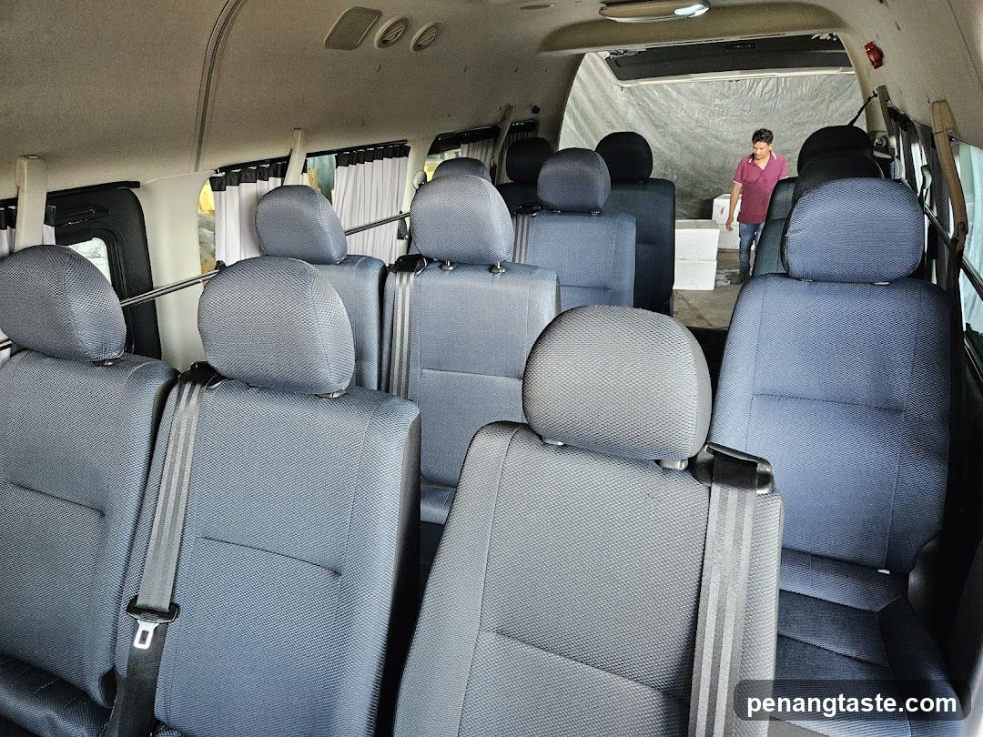 Interior of a van with multiple seats and a person in the background