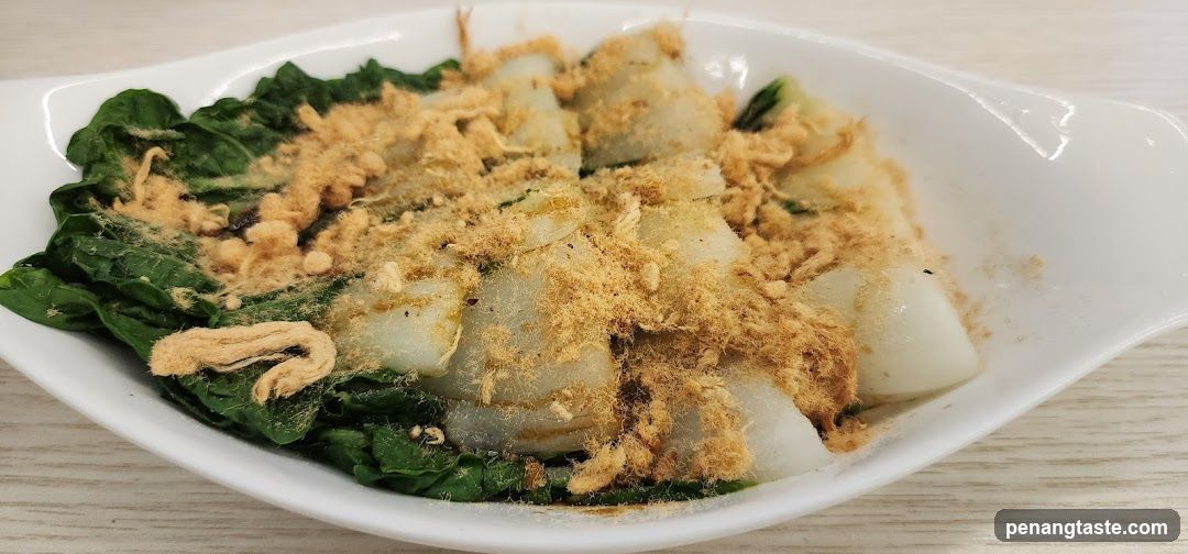 Dish with greens and fried topping