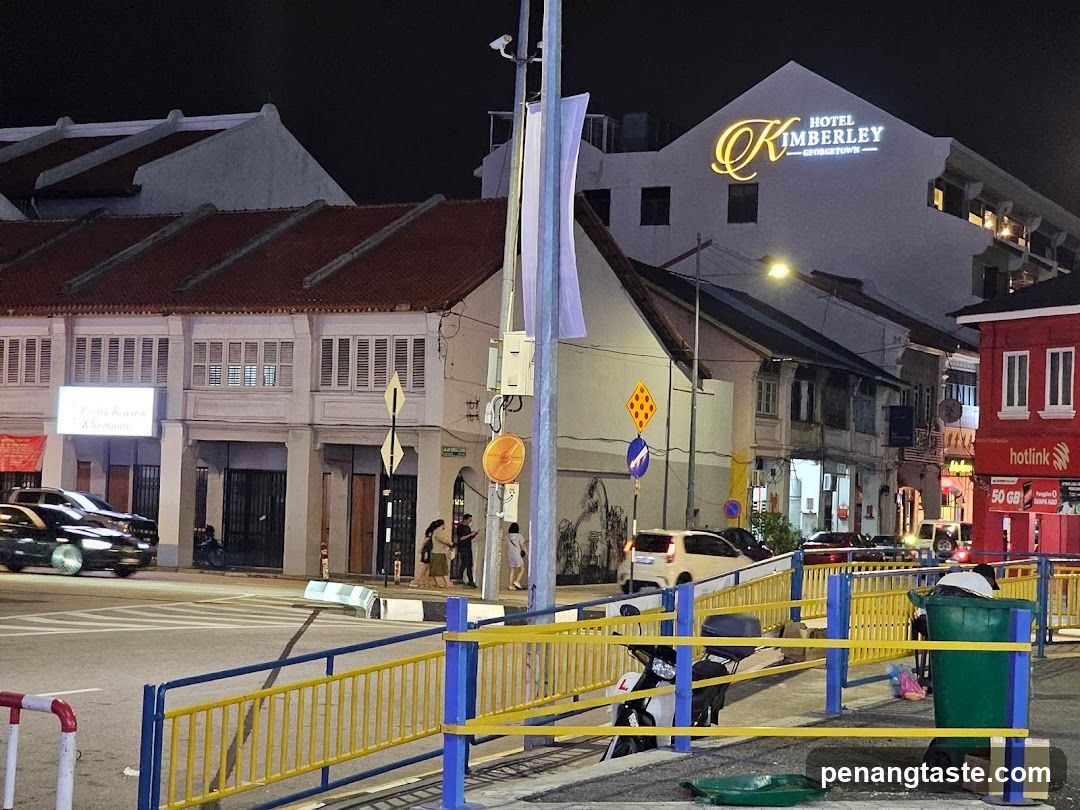 Night street scene with hotel and shops