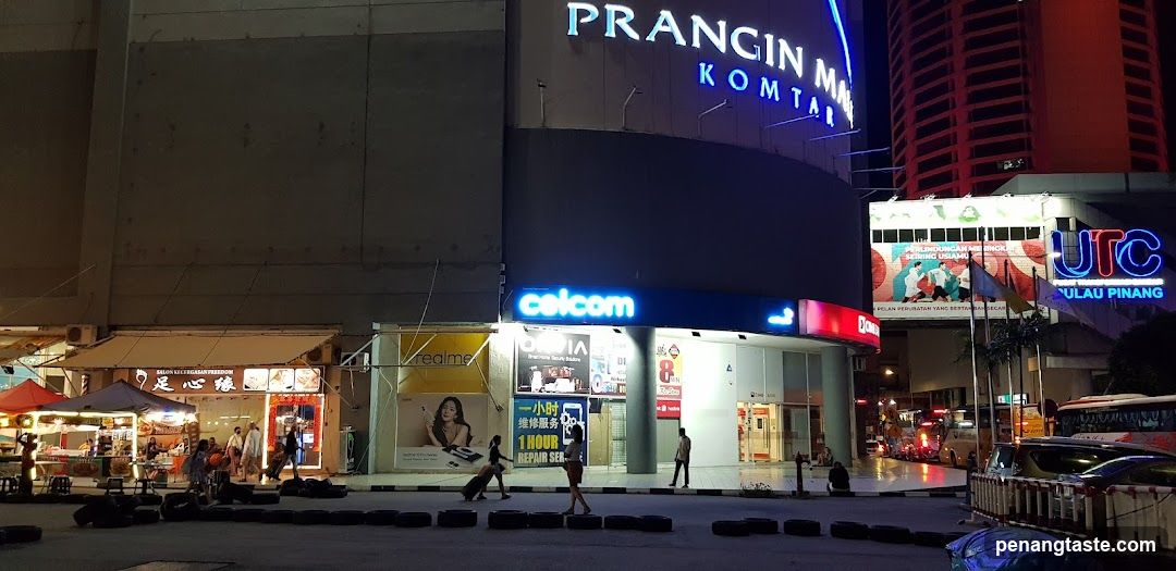 Night street scene with storefronts and signage