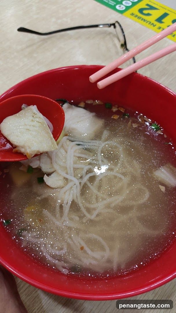 Bowl of Noodle Soup with Chopsticks and Spoon