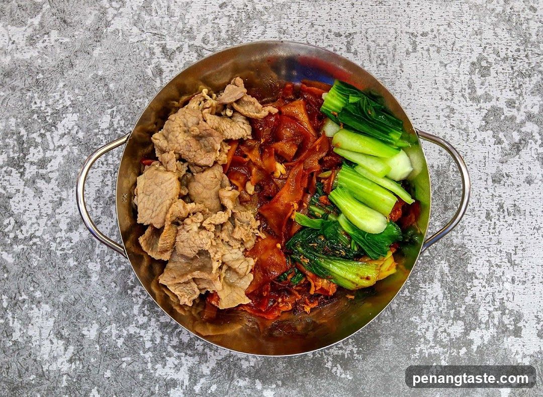 Korean-style stir-fry with bok choy and beef in a metal bowl