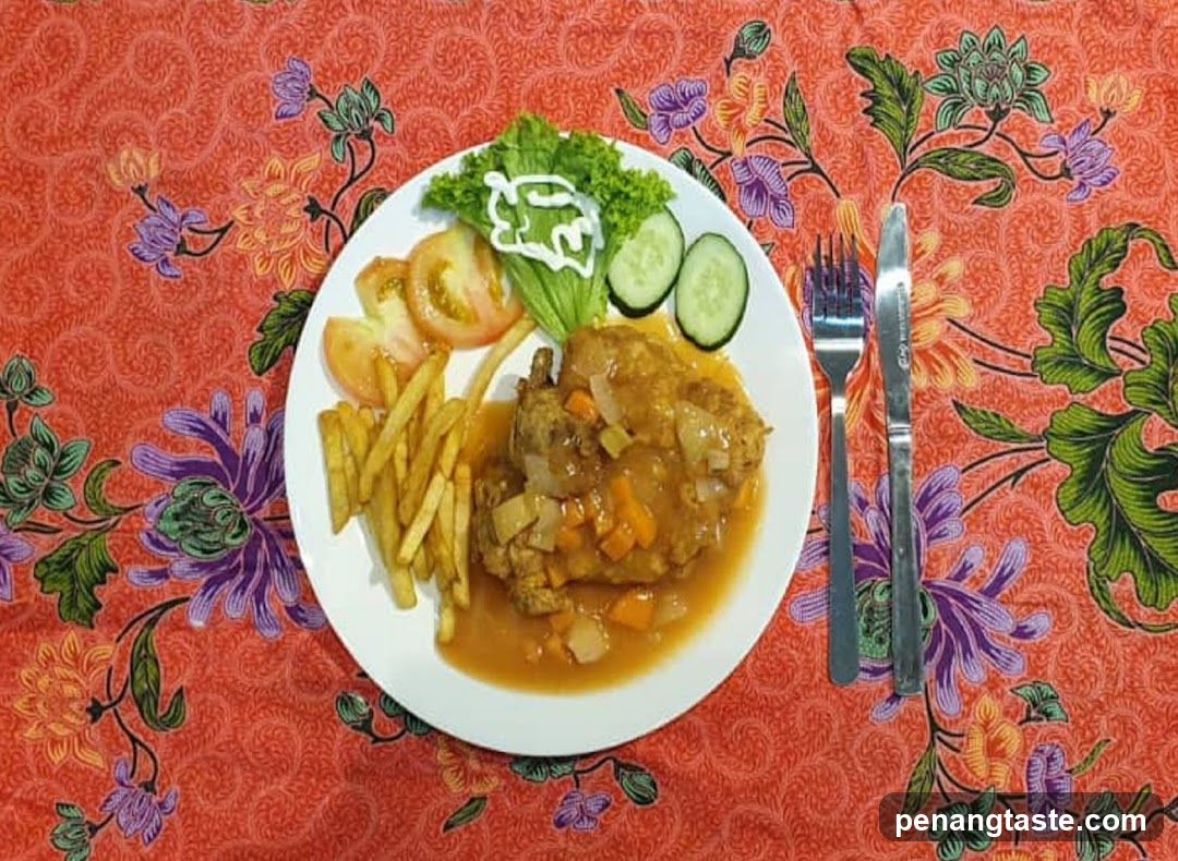 Plate of Chicken Curry with Fries and Salad