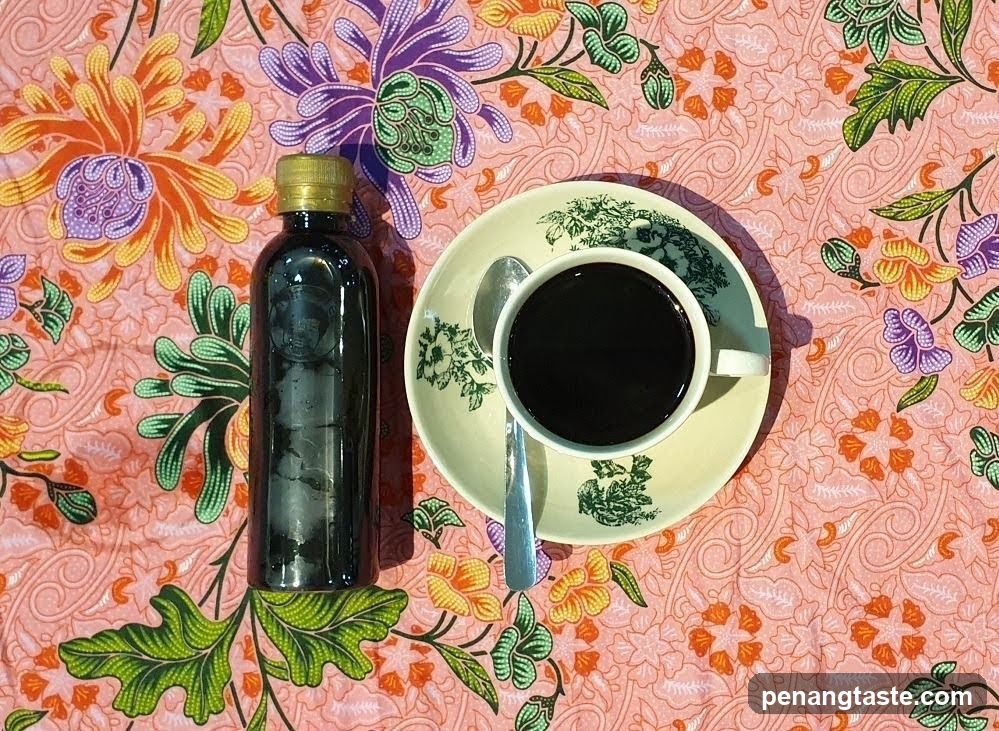 Coffee and Bottle on Floral Tablecloth