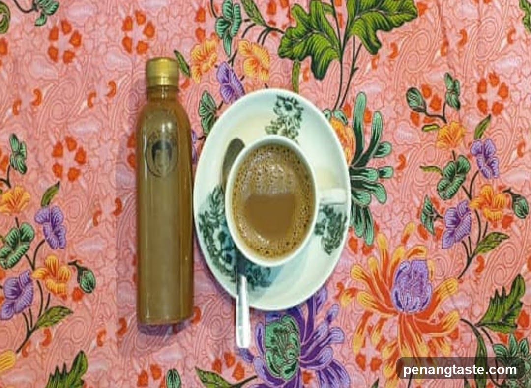 Cup of Coffee and Bottle on Floral Tablecloth
